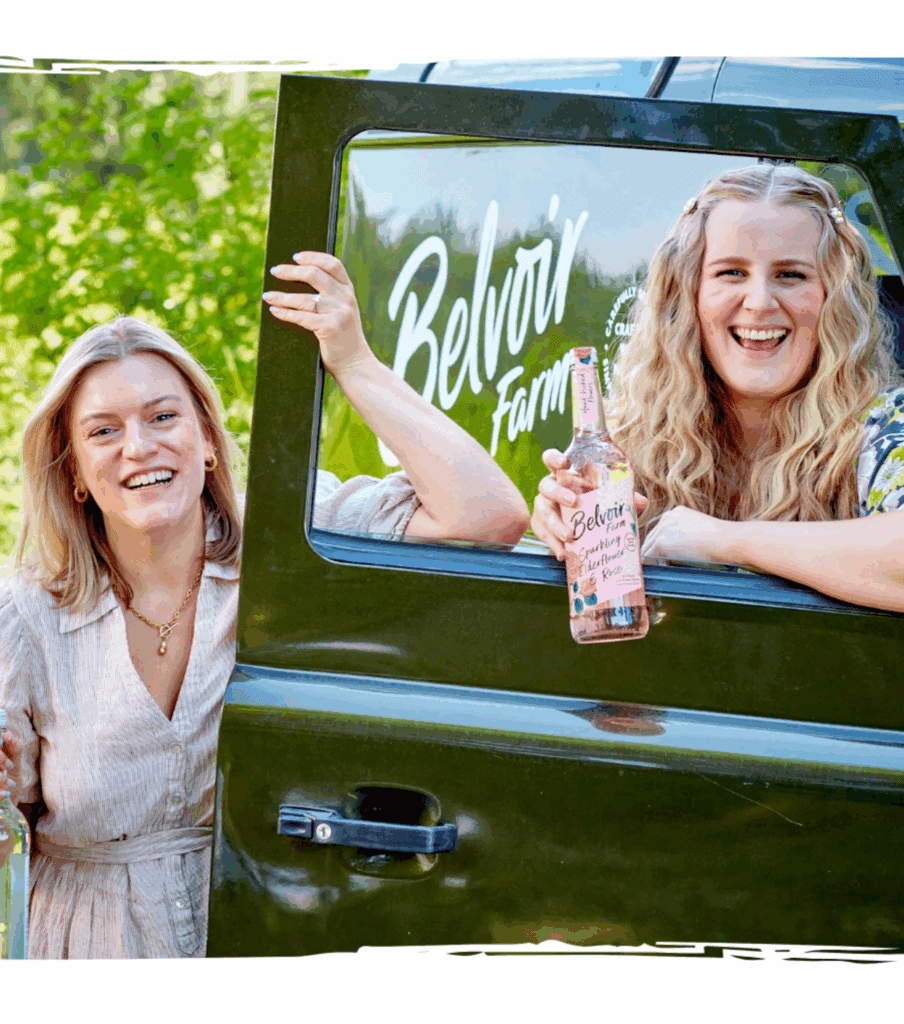 Two smiling women with a Belvoir Farm mocktail
